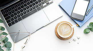 Image of a desk with pen and paper near a laptop and coffee symbolizing a meeting approval with Imagine Insurance Advisors for a Medicare insurance review.